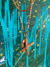 Load image into Gallery viewer, 'x' and 'o' brass initial charm hanging on brass cube chain necklace